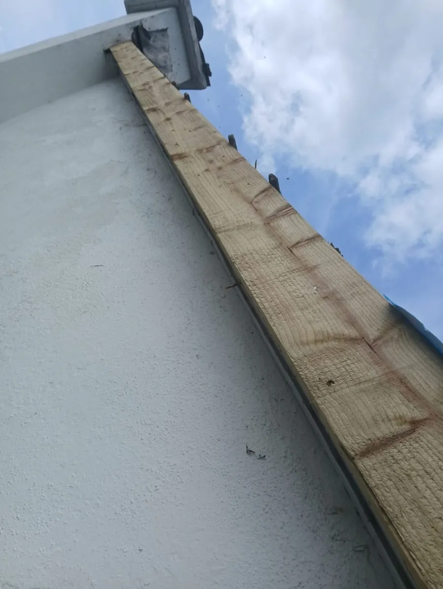 Timber edge batten fixed along a rendered wall at a flat roof edge, Global Roofing and Guttering, Dublin
