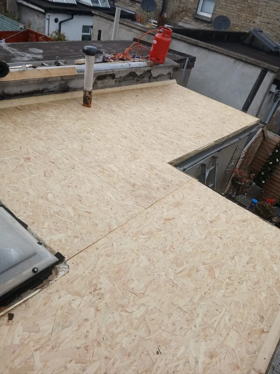 New OSB deck boarded over a flat roof extension beside a rooflight, Global Roofing and Guttering, Dublin