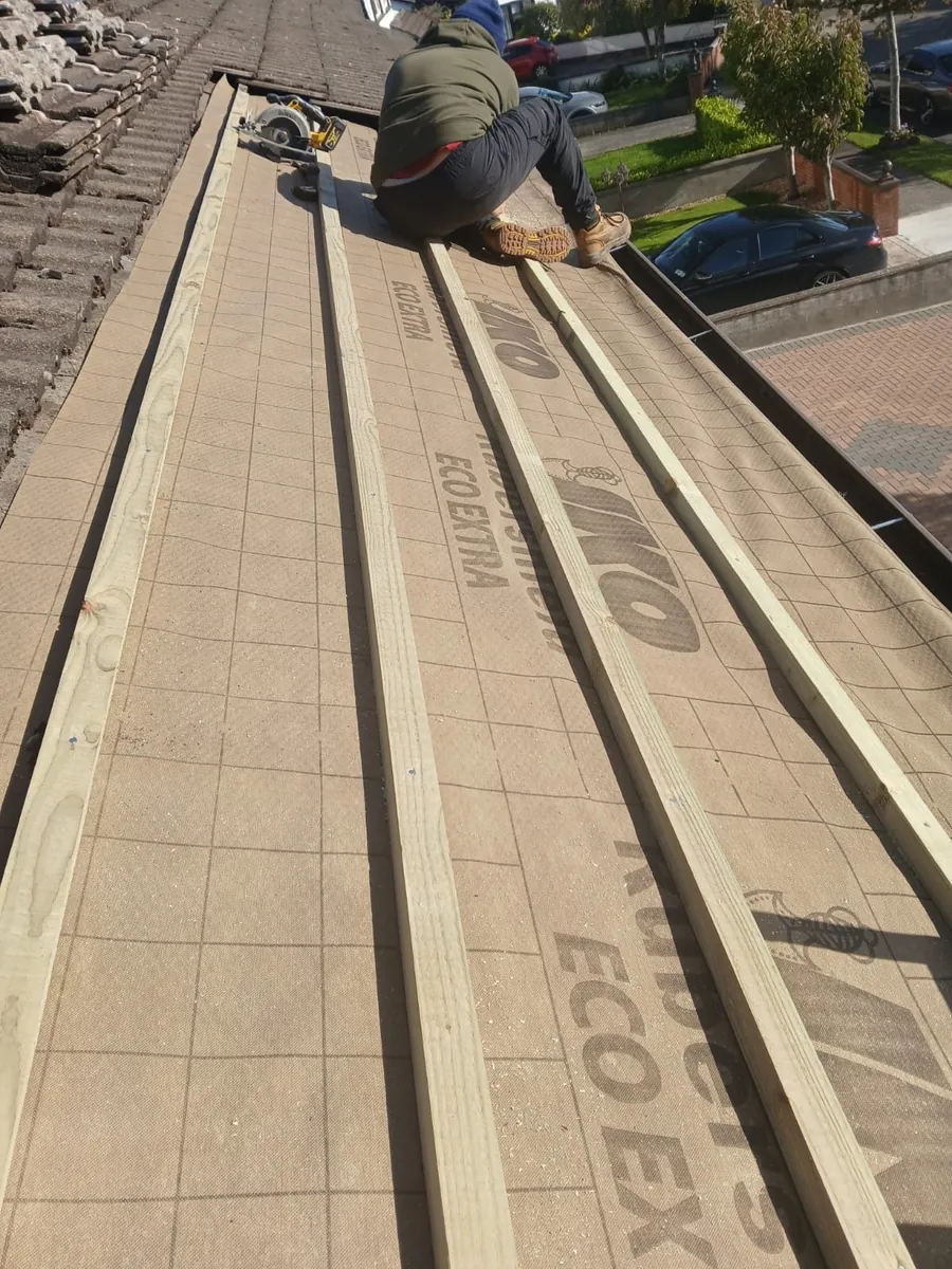 Roofer fixing battens over new membrane above a residential street, Global Roofing and Guttering, Dublin