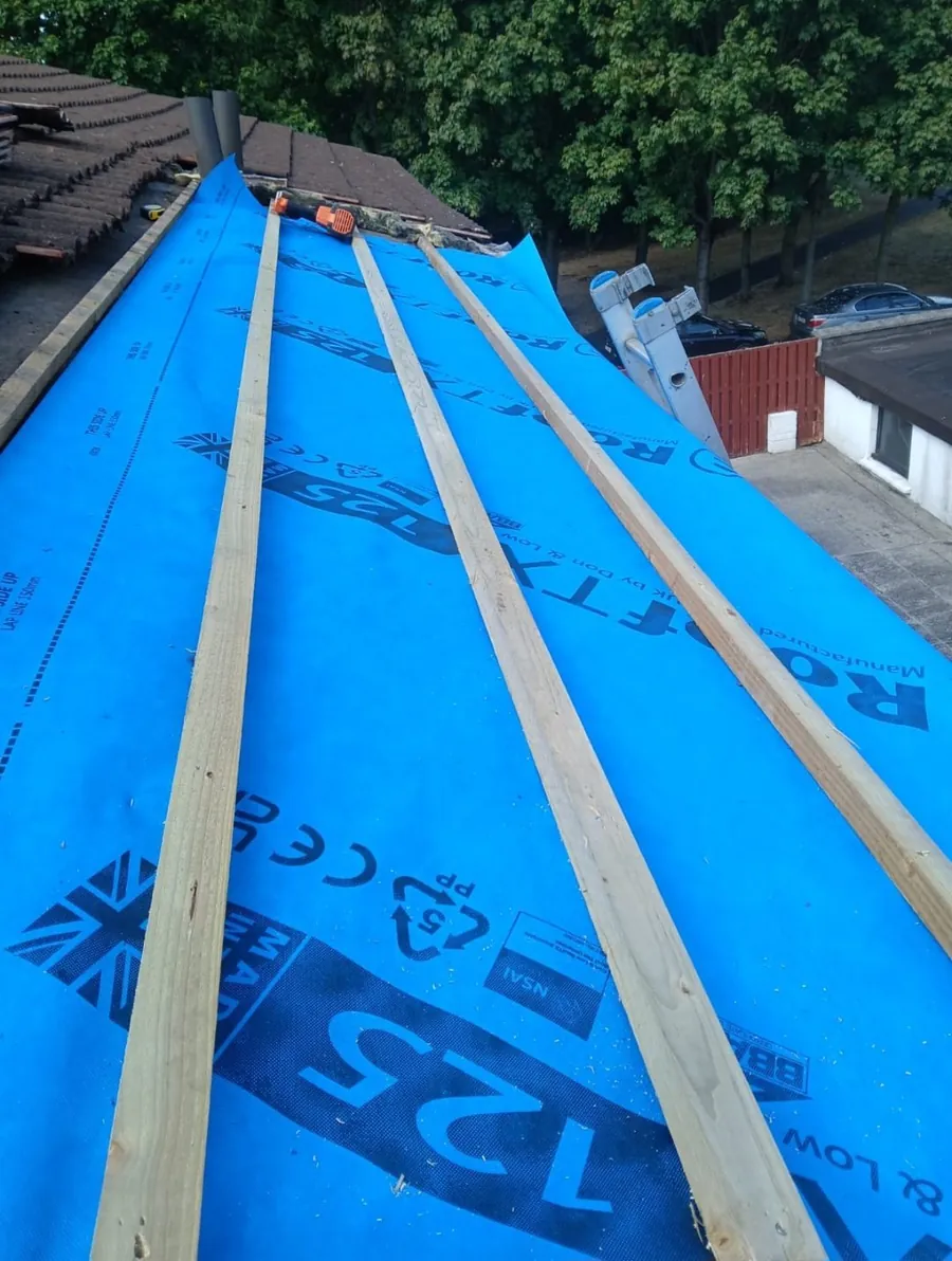 Tiled roof stripped back to blue breathable membrane and new battens, Global Roofing and Guttering, Dublin
